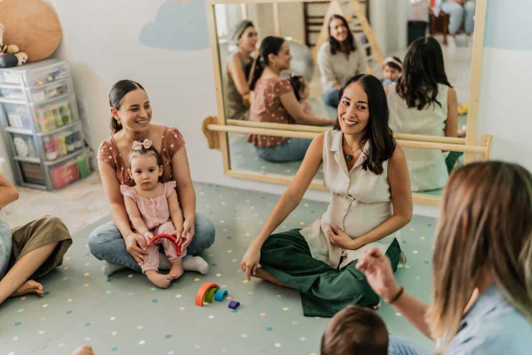 Mothers talking in a support group at playroom
