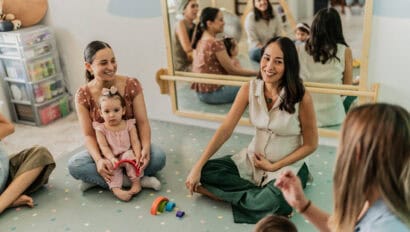Mothers talking in a support group at playroom