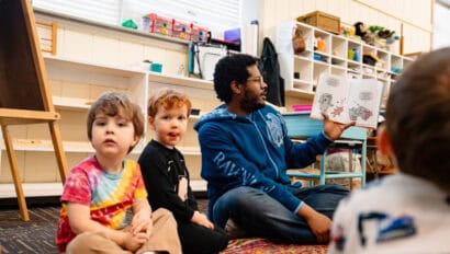 Montessori Guide signing with preschoolers at Westport Montessori in Kansas City