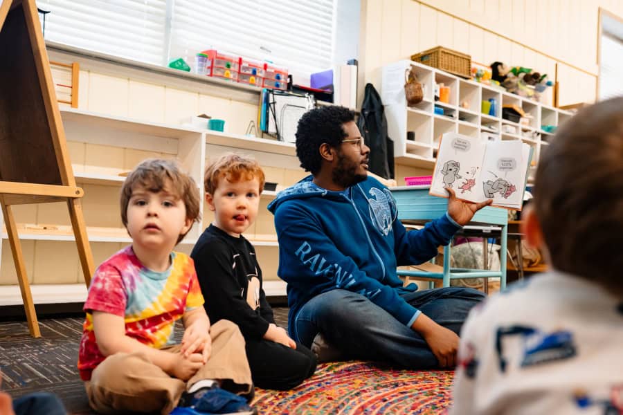 Montessori Guide signing with preschoolers at Westport Montessori in Kansas City